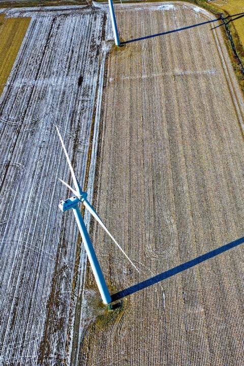 Aerial view of farms with wind turbines and a country road - engaging with suppliers on Scope 3