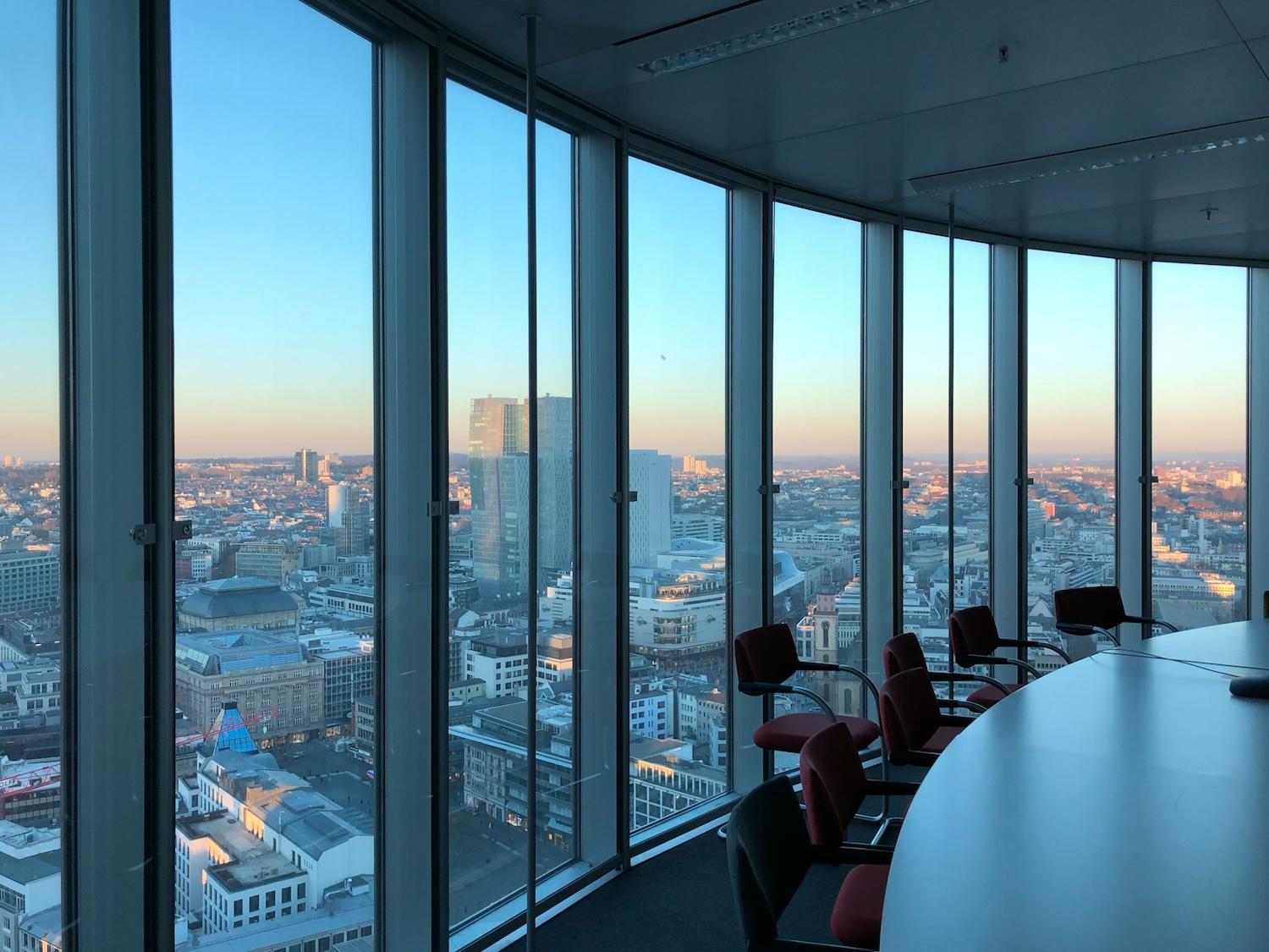 board room with glass windows and city skyline in the background