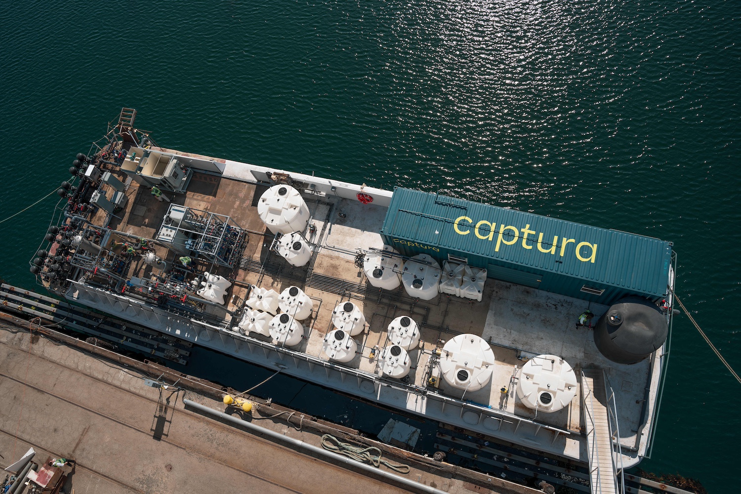Captura's direct ocean capture pilot system floating in the water attached to the Port of Los Angeles.