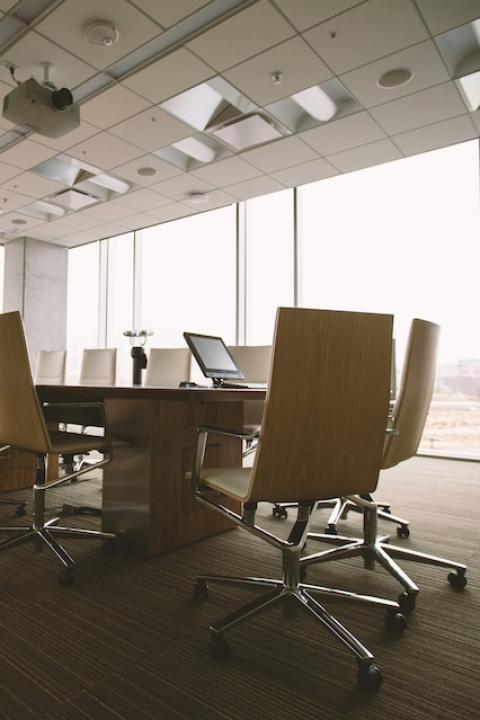 An empty table in a boardroom. 