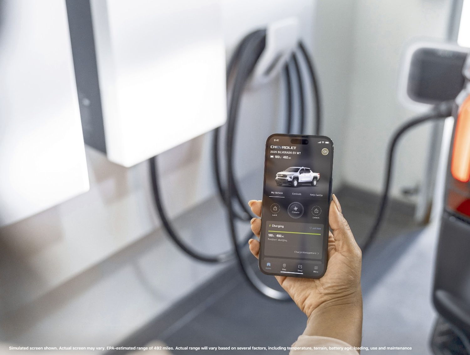 Chevrolet Silverado EV — woman check the charge of the EV on a mobile app