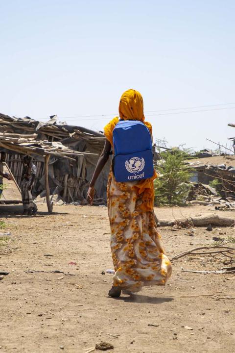 climate change refugee miriam who was displaced by floods in northern ethiopia walks to school with unicef backpack