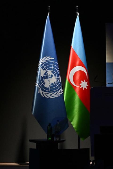The UNFCCC flag next to the flag of Azerbaijan at COP29.