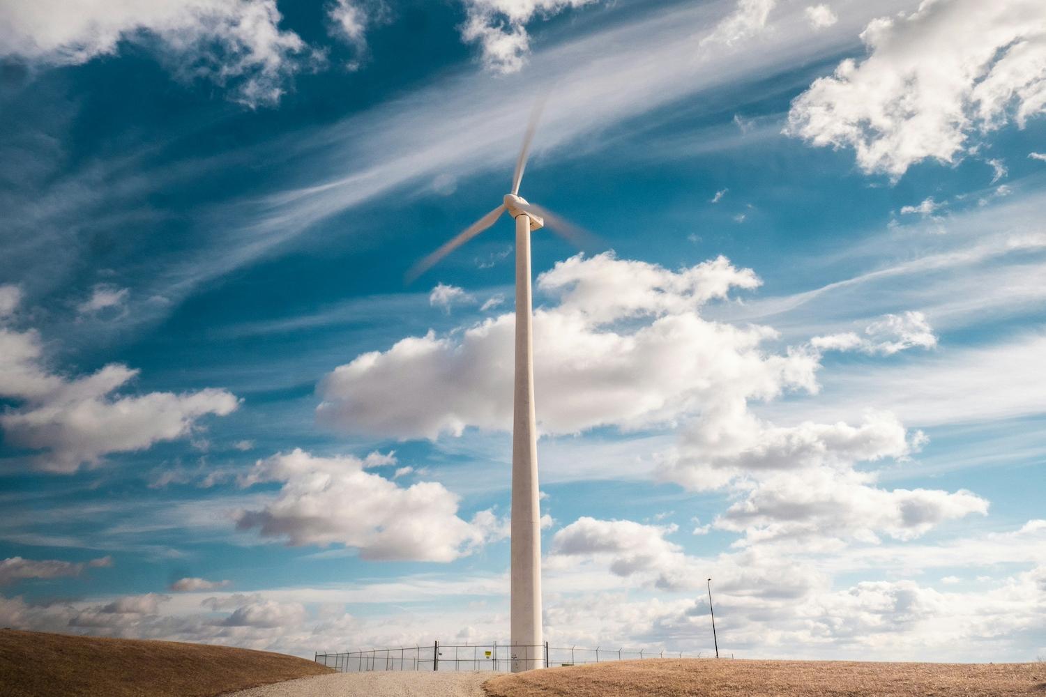 A wind turbine in front of a cloudy sky — data center
