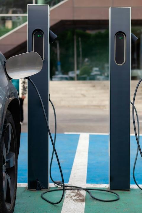 Two EVs parked at charging stations — grid resiliency