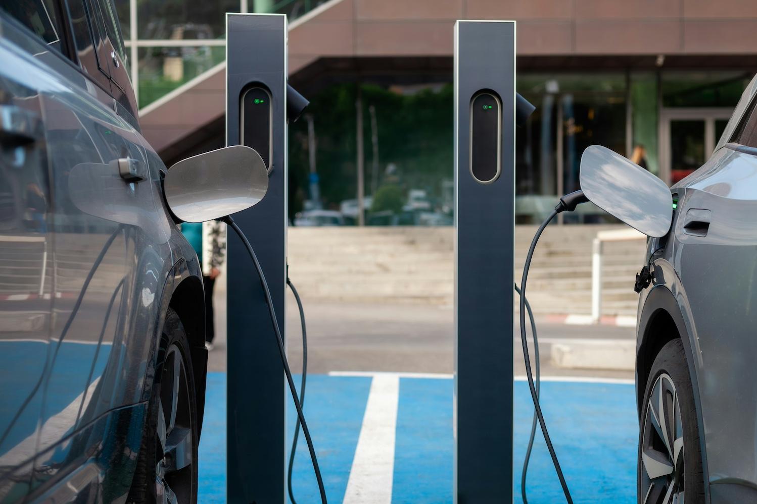 Two EVs parked at charging stations — grid resiliency