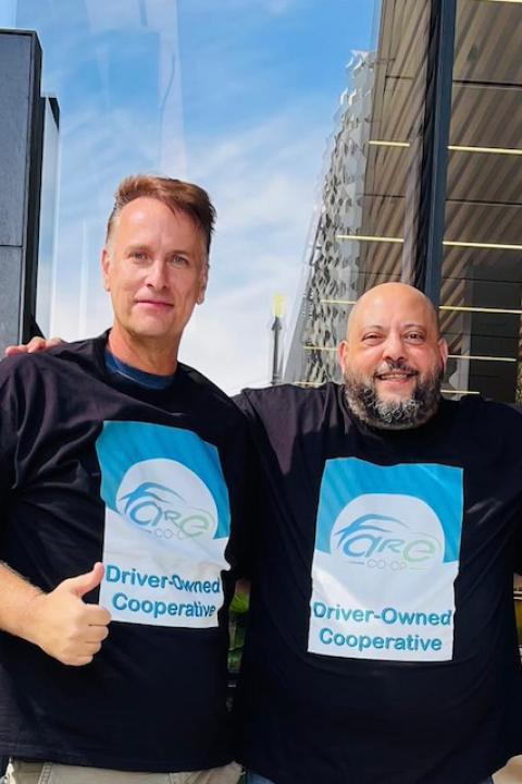 Ivan Olivo, AJ Attia and Danny Golnik stand together in front of the Uber headquarters sign in Fare Co-op t-shirts.