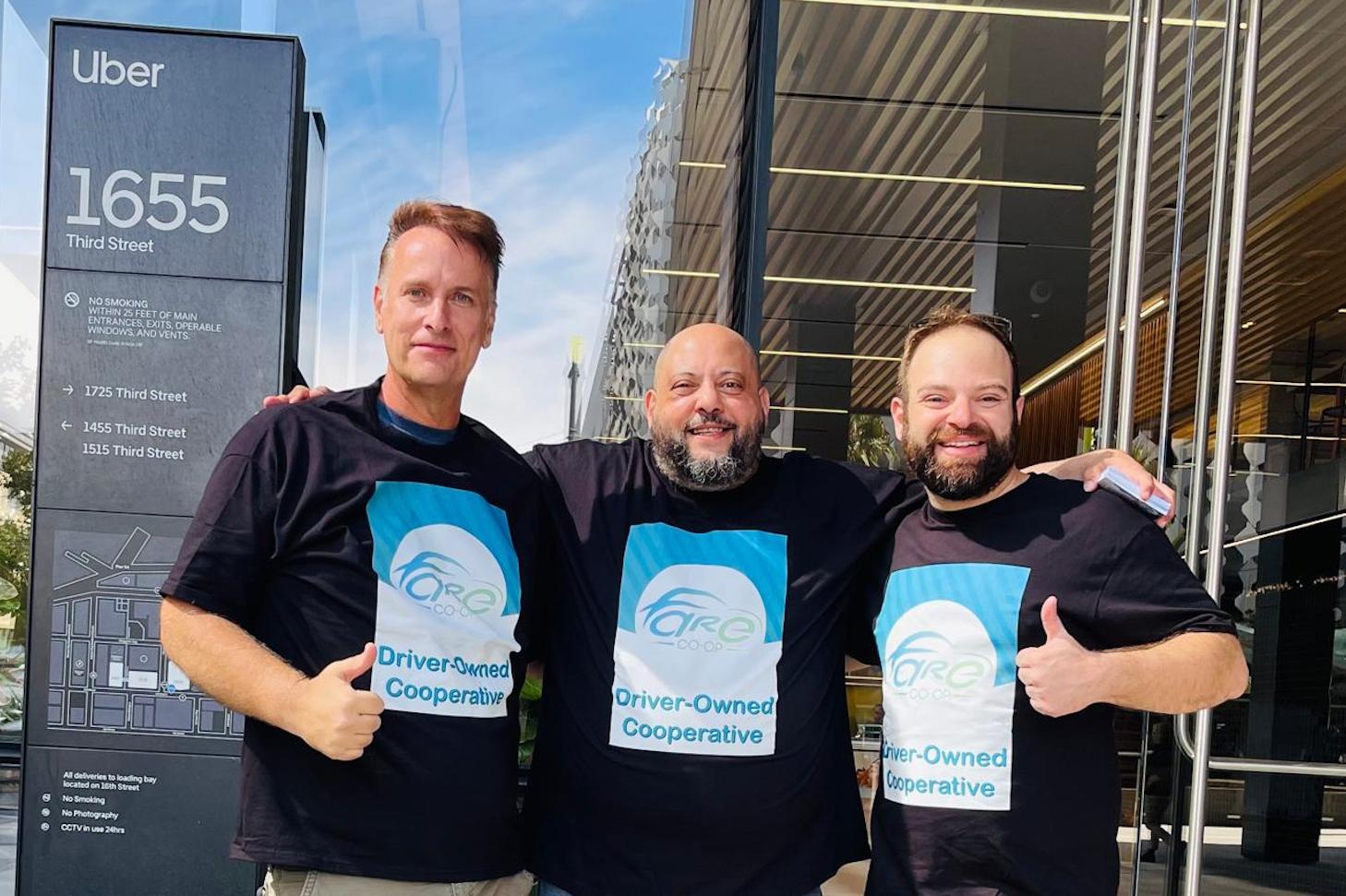 Ivan Olivo, AJ Attia and Danny Golnik stand together in front of the Uber headquarters sign in Fare Co-op t-shirts.
