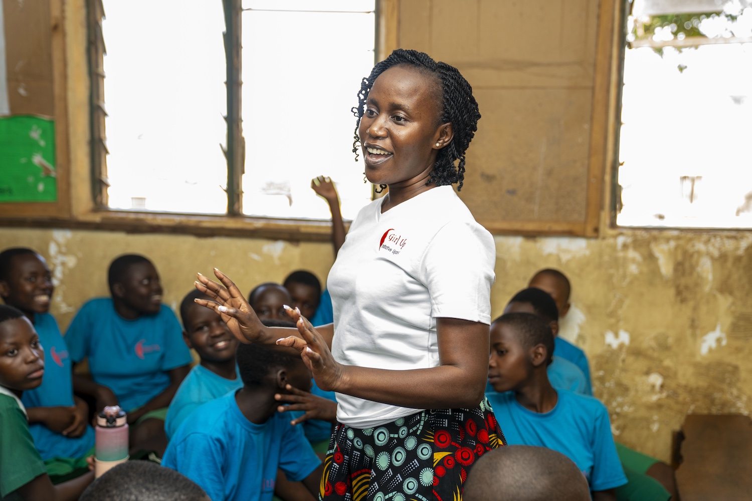 A Girl Up Initiative Uganda teacher addresses a group of young students.
