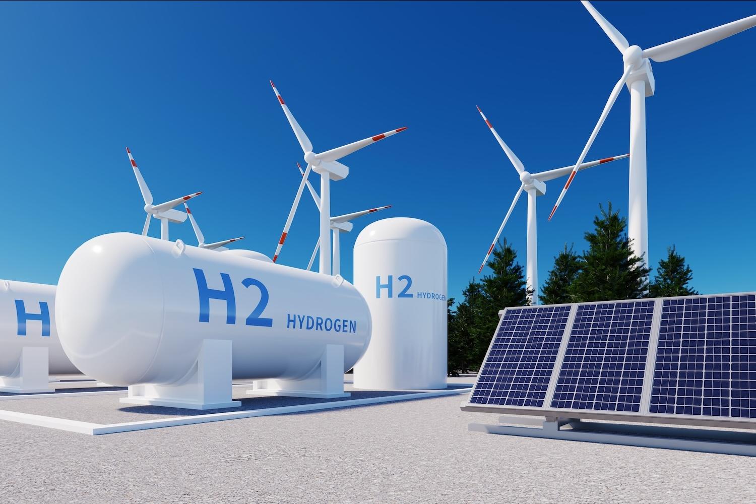 A rendering of a hydrogen storage tank near wind turbines and solar panels — green hydrogen