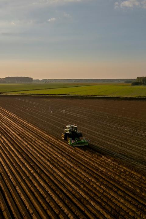 A tractor plowing a farm field — Central Valley