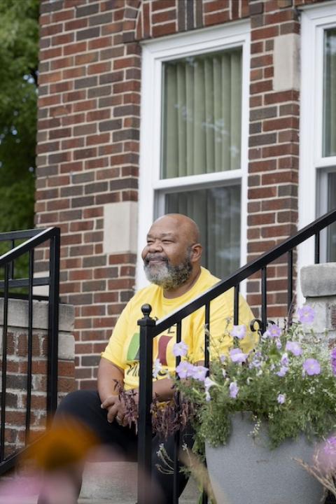 Jeffrey Jones, executive director of Hope Village Revitalization, sits on the front steps of the La Salle Eco-Demonstration Home.