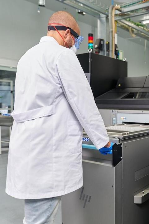 HP Metal Jet S100 Operator 3D printing metal parts in a lab