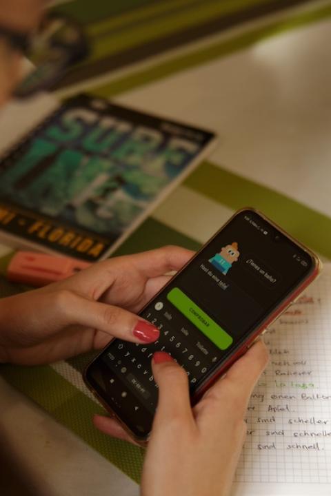 A person uses the Duolingo app on their cell phone — immigrant entrepreneurs
