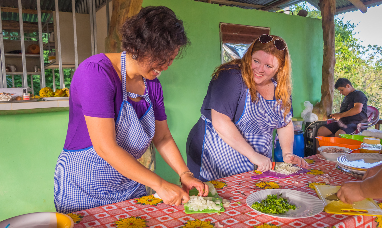 Travelers and locals cook together on an Intrepid Travel trip in Costa Rica — responsible travel