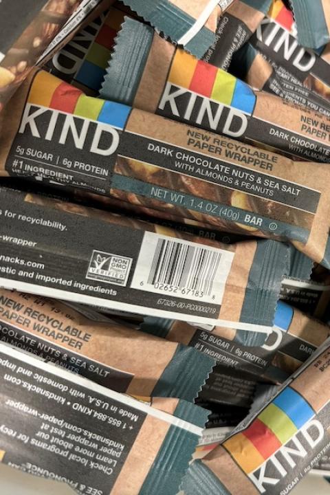 A pile of dark chocolate nuts and sea salt Kind bars in the new recyclable paper wrappers.