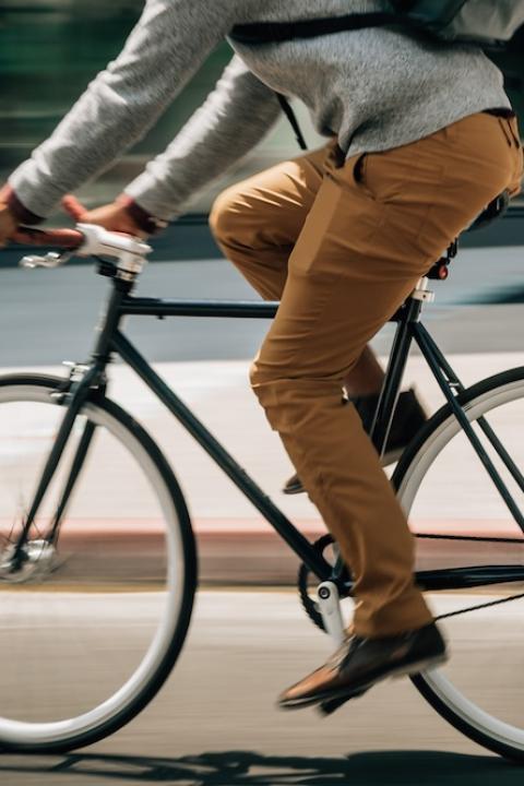 Man riding a bicycle in Livsn pants made from recycled buoys