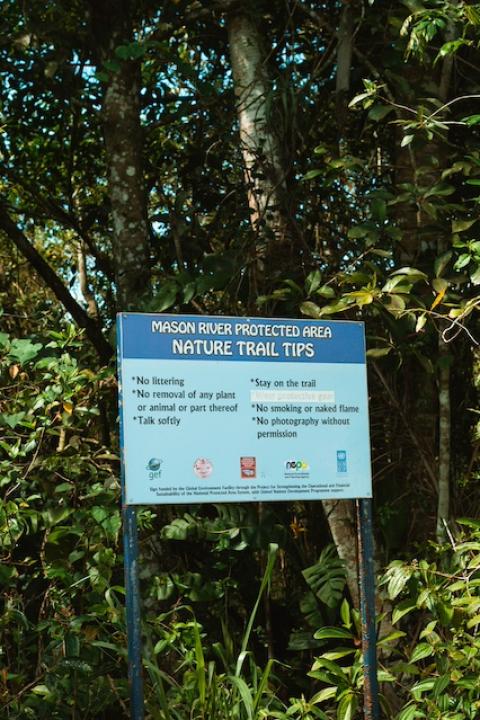 A sign reads "Mason River Protected Area: Nature trail tips." — wetlands
