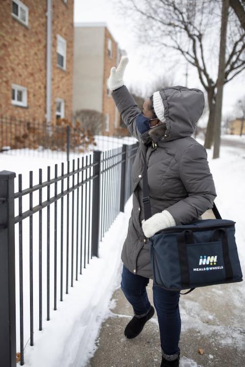 Meals on Wheels volunteer delivering meals in her community