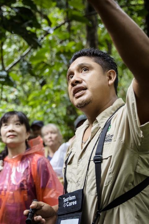 A local guide points out Panama’s biodiversity while walking through the rainforest with travelers — Meaningful Travel Map