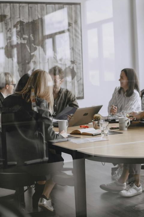 People sit in a conference room — menopause friendly workplace