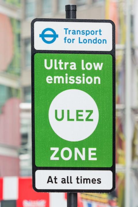 A green sign designating London's Ultra Low Emission Zone — net-zero ciites