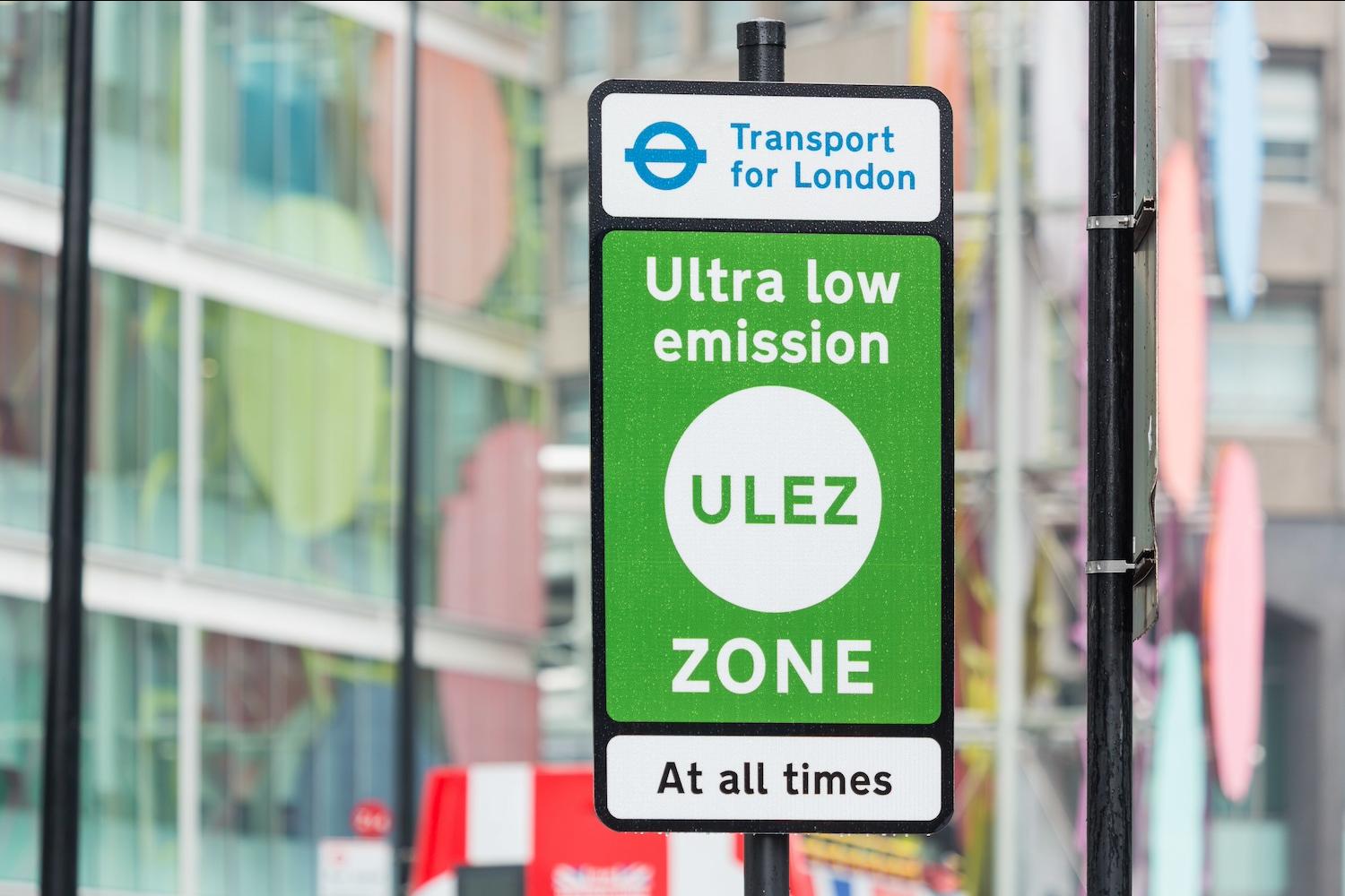 A green sign designating London's Ultra Low Emission Zone — net-zero ciites
