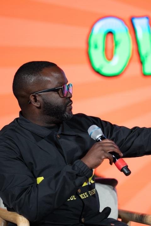 Daniel Blackman of Renaissance94 speaks on stage at Overheated Atlanta — climate action, climate optimism