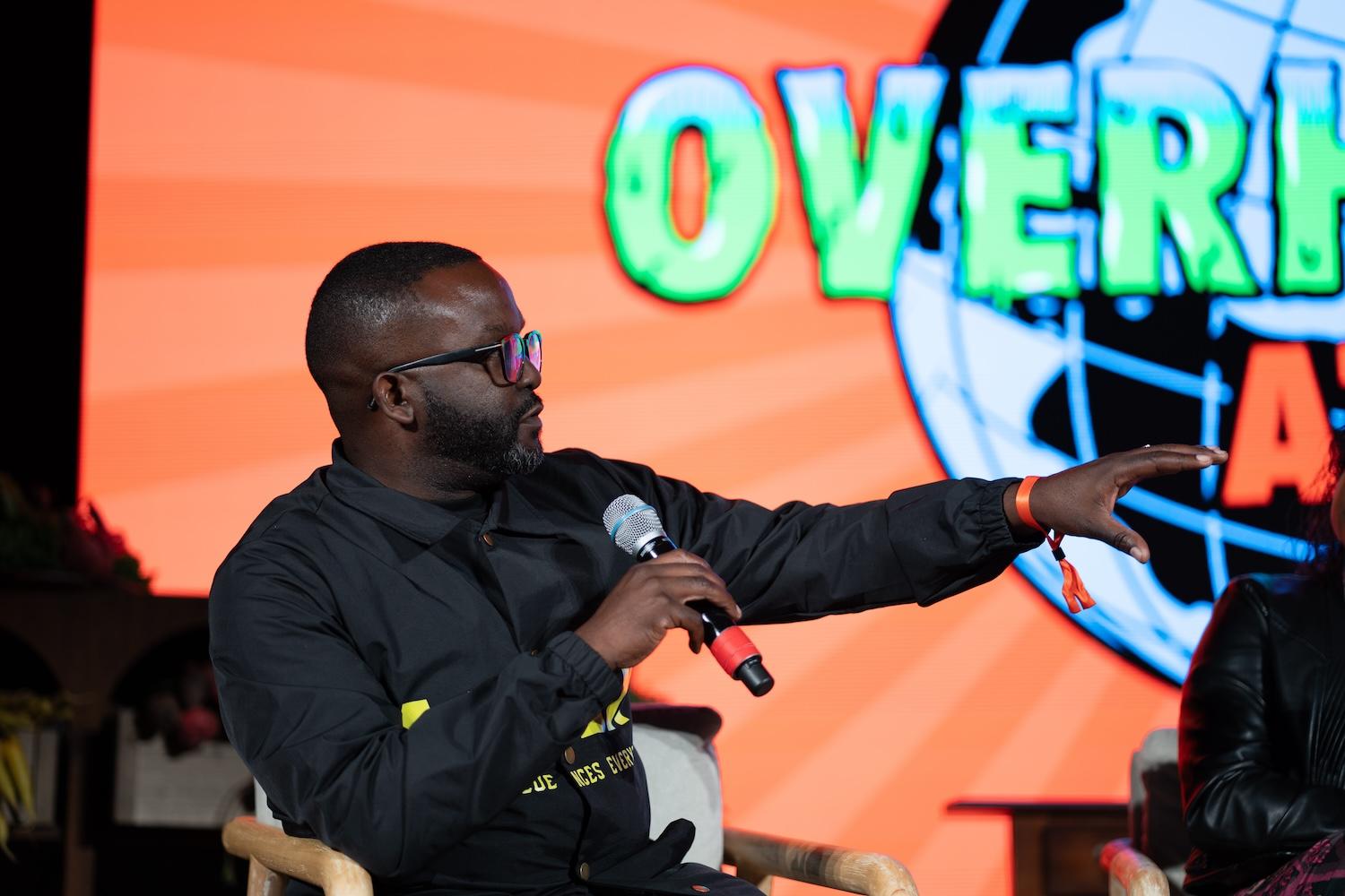 Daniel Blackman of Renaissance94 speaks on stage at Overheated Atlanta — climate action, climate optimism