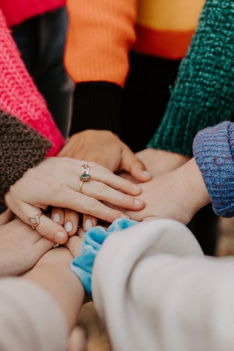 people putting their hands together