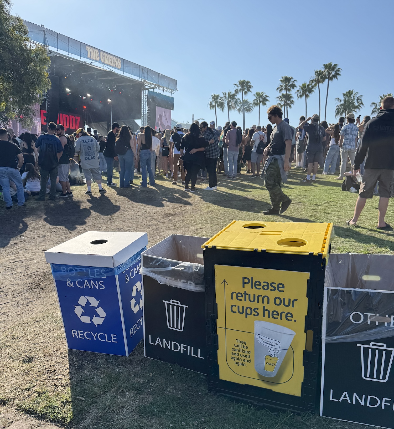 compost trash and recycling bins at a music festival — sustainability at music festivals