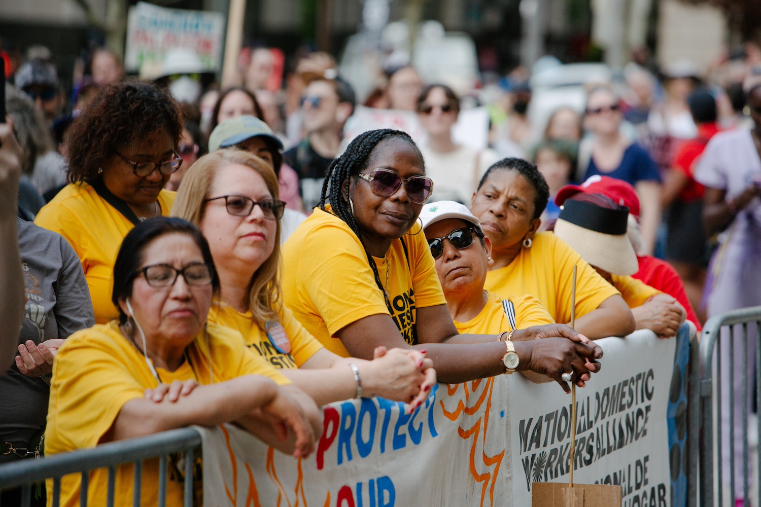 Sandra Bryant stands among other National Domestic Workers Alliance members wearing yellow alliance t-shirts at a rally supporting the POWER Act.