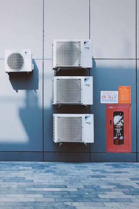 Air conditioning units on a wall — refrigerant emissions