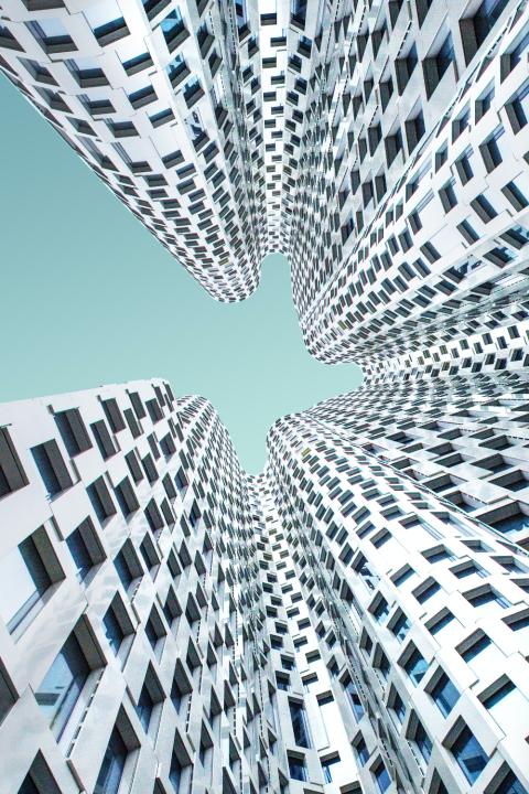 A photo looking up at skyscrapers.