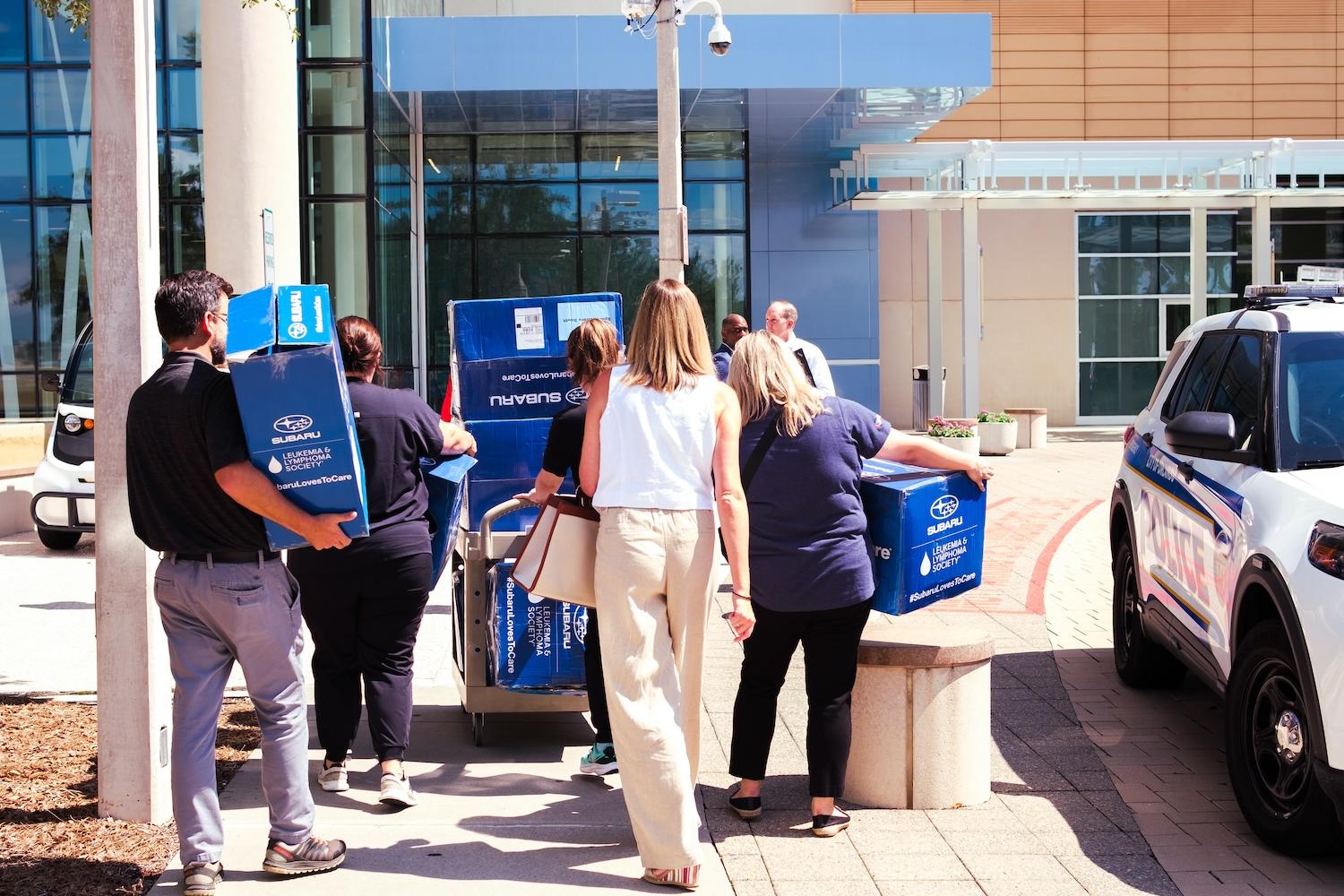 Sport Subaru employees deliver care packages to cancer patients at an Orlando hospital
