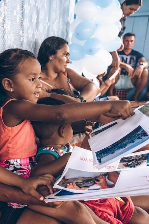 Children and adults sit together participating in The Waterschool curriculum in Brazil — Swarovski Foundation