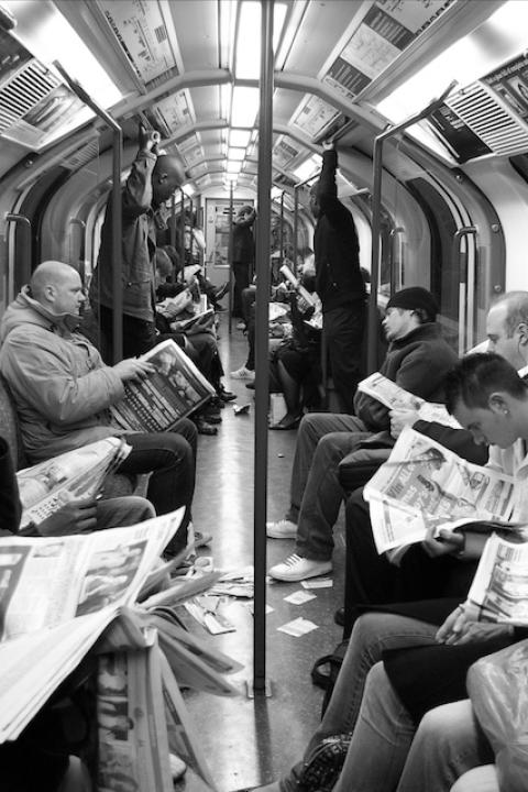 People reading newspapers on a subway — user needs model