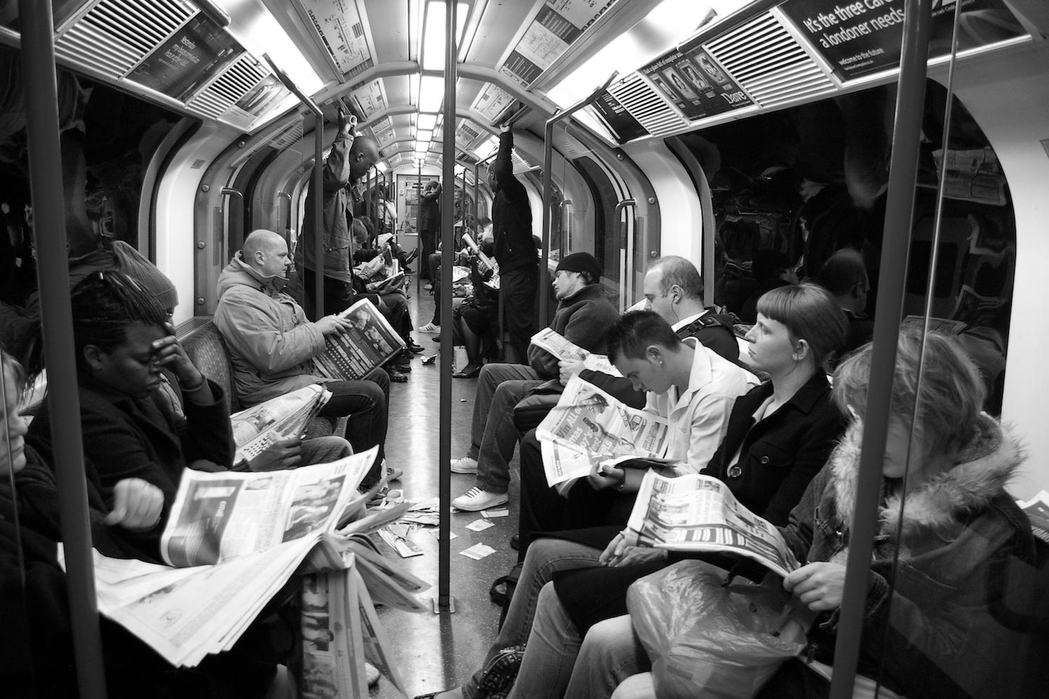 People reading newspapers on a subway — user needs model