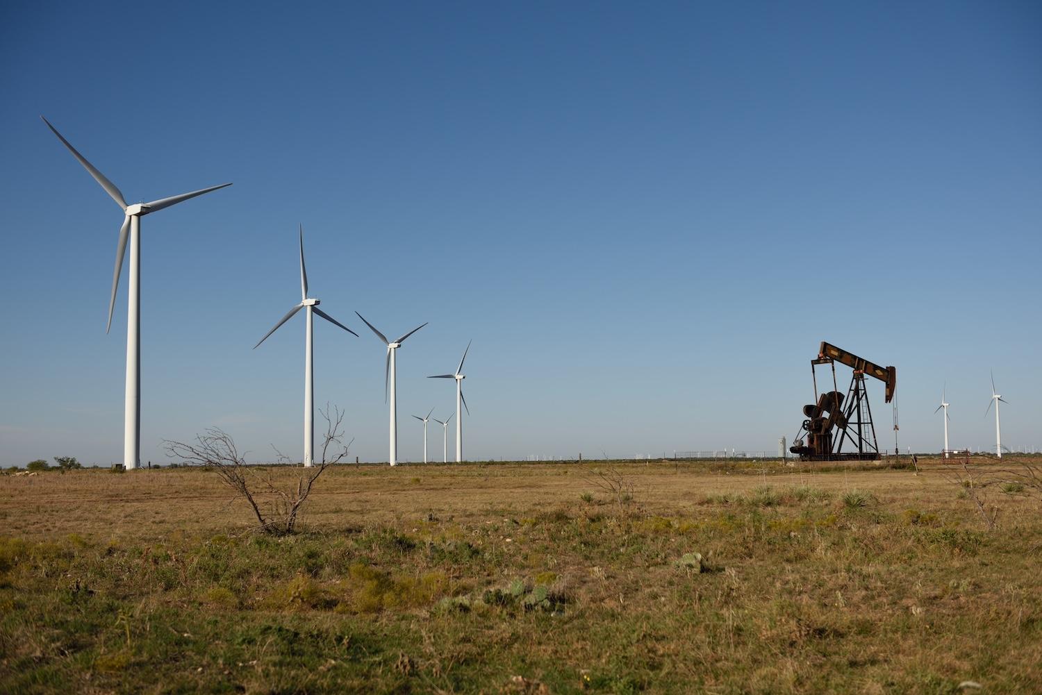 wind turbines and oil pump side by side in texas — renewable energy in texas