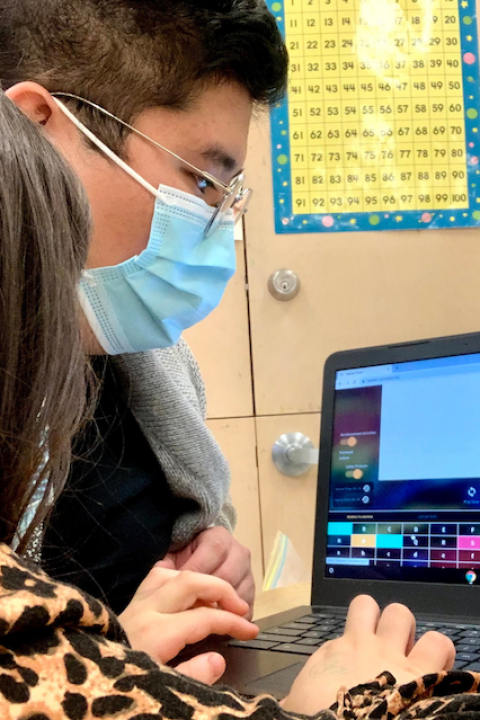 A child working on a computer with a Chapter One tutor.