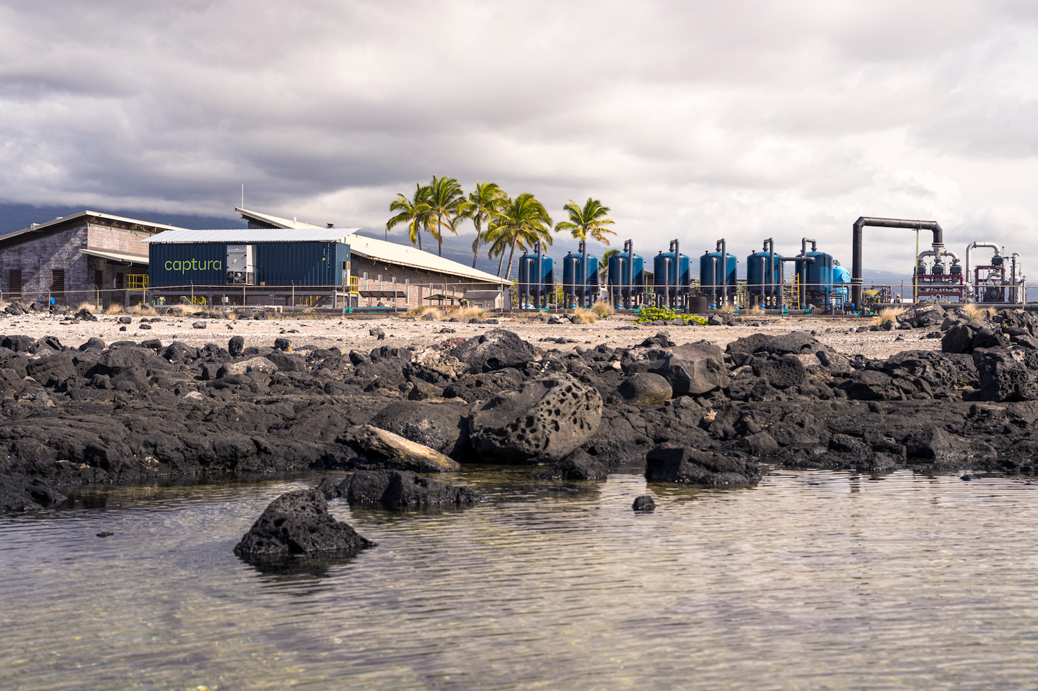 The Captura pilot facility in Hawaii on the coast surrounded by palm trees — direct ocean capture