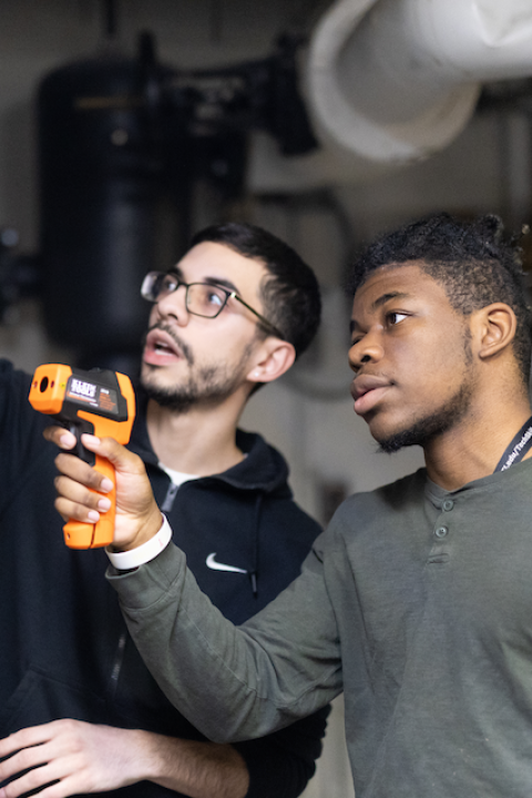 David Sepulveda advising a student during a hands-on green building lesson — green jobs