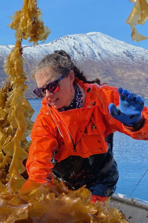 woman on a boat in Alaska processing seaweed for use in SuperCrude