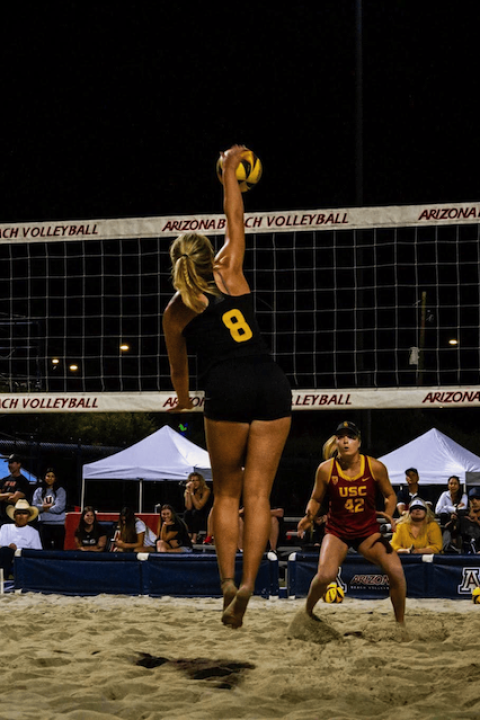 Kate Fitzgerald jumps up to spike a volleyball during an ASU game — student-athletes